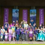 Photo courtesy Timecatcher Photography/ Sequim Lavender Festival Executive Director Kelly Iriye cuts a ceremonial ribbon on July 17 at the James Center for the Performing Arts bandshell courtesy the Sequim-Dungeness Valley Chamber of Commerce to commemorate the opening of the festivals 30th year. Iriye is surrounded by Sequim dignitaries, farmers, business people, volunteers, Chamber staff, ambassadors and past and present board members.