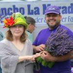 Sequim Gazette photo by Monica Berkseth
Sandra Bliss of San Antonio, Texas proudly poses with Juan Gonzalez, owner of Rancho La Morada Lavender Farm, during Sequim Lavender Festival in the Park.