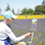 Linda Tilley of Port Townsend paints a lavender field at Olympic Bluffs Cidery & Lavender Farm on July 18 as one of several artists participating in the Olympic Peninsula Art Associations first Sequim Plein Aire Paint Out.