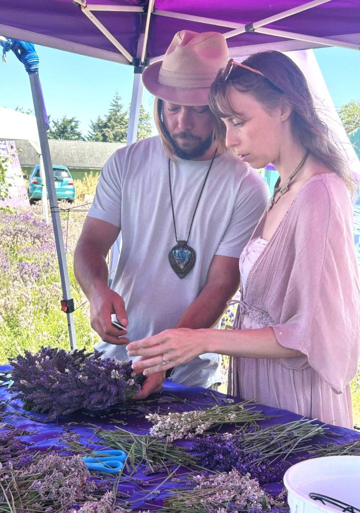 Sequim Gazette photo by Matthew Nash 
Brandon Denham and Bonnie Toye of Port Angeles work together to make a lavender wreath at Melis Lavender. The couple moved to the area in January, they said, and they made a plan to visit many farms.