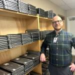 Sequim Gazette photo by Matthew Nash
Beau Young, Sequim School Districts director of technology, stands by some of the 800 laptops ordered through the state program Computers 4 Kids for Helen Haller Elementary. The program provides refurbished, state-surplus computers and laptops to public schools and Educational Service Districts across Washington. Computers are refurbished at the Airway Heights Corrections Center and redistributed to schools by ESD 101.