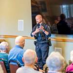 Sequim Police Officer Roderic Sisk was part of a three-person law enforcement panel that advised seniors at The Lodge about red flags that indicate a scam.