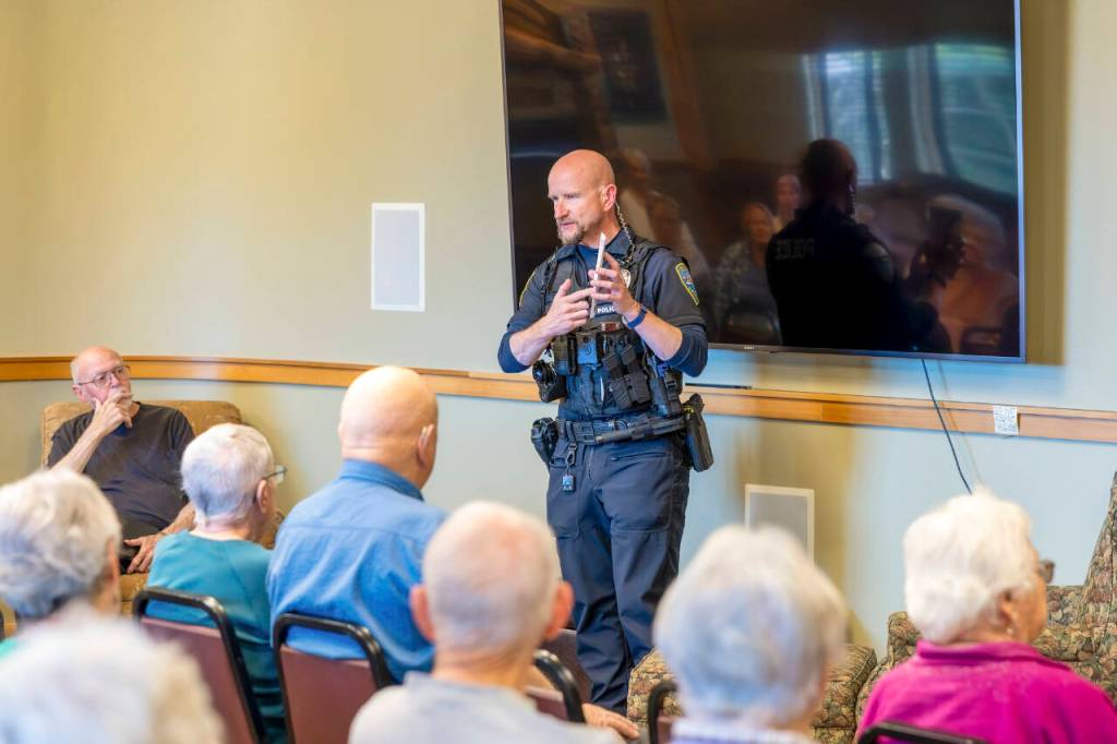Sequim Police Officer Roderic Sisk was part of a three-person law enforcement panel that advised seniors at The Lodge about red flags that indicate a scam.