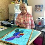 Sequim Gazette photos by Matthew Nash
Beverly Beighle of Dungeness is the Sunbonnet Sue Quilt Shows Featured Artist on Aug. 7-8. Past recipients selected her for her vibrant work, including the art quilt Hummingbird, shown here with Beighle in her home studio.