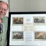 Sequim Gazette photo by Matthew Nash 
Phil Castell, a Strait Stamp Society club member, kneels by one of the pages from his Bicentennial of 1976 display for the Strait Stamp Society show at 9:30 a.m.-4 p.m. Saturday, Aug. 8 at the Guy Cole Event Center.