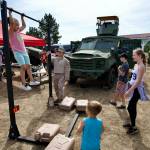 Sequim Gazette file photo/ Children attempt pull-ups in the U.S. Marine Corps booth at last years Unity of Effort. The marines are one of several military branches to return this year to the event on Aug. 8.
