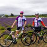Zoe Anderson, left, and her wife, Ruth Anderson, both of Olympia, pose with their bicycles at Olympic Bluffs Cidery & Lavender Farm late Saturday morning, Aug. 1, as they participated for the first time in the annual Tour de Lavender bicycle tour of area lavender farms. The pair said they learned of the event through social media and that the lavender fields, views of the sea and organization of the ride would bring them back. Proceeds support the Peninsula Trails Coalitions work on the Olympic Discovery Trail.