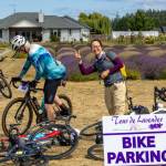 Sequim Gazette photos by Tom Buscher
A woman flashes a peace sign as Tour de Lavender participants park their bicycles at B&B Lavender Farm on Saturday, Aug. 1. The farm served as one of six stops where riders could rest before continuing their ride through the Sequim-Dungeness area in support of the Peninsula Trails Coalition and the Olympic Discovery Trail.