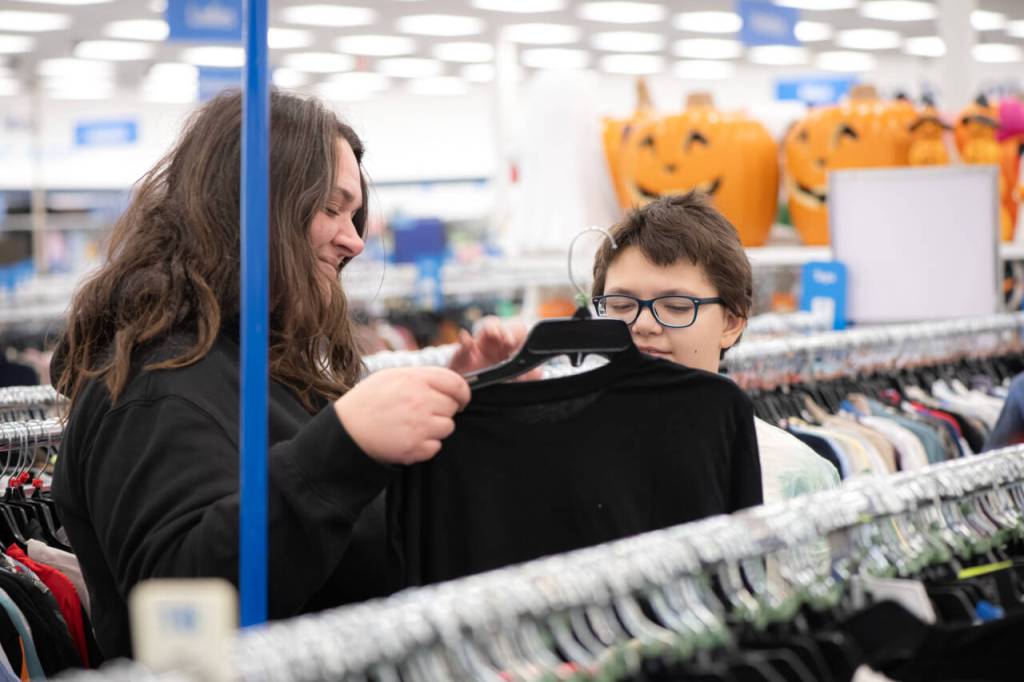 Adrienne Kaestner, left, helps her son Robert, 10, shop for clothing on Saturday, Aug. 1. Participating families received a $100 gift card per child to shop for back-to-school items at Ross, thanks to donations made to the nonprofit Having Understanding Means Acting Now (H.U.M.A.N.).