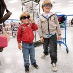 Ryder Friedman, 4, left, and his brother Asher, 7, strike a too-cool-for-school pose as they try out sunglasses displayed at Ross Dress for Less during Saturdays Shoes with Souls back-to-school shopping event.