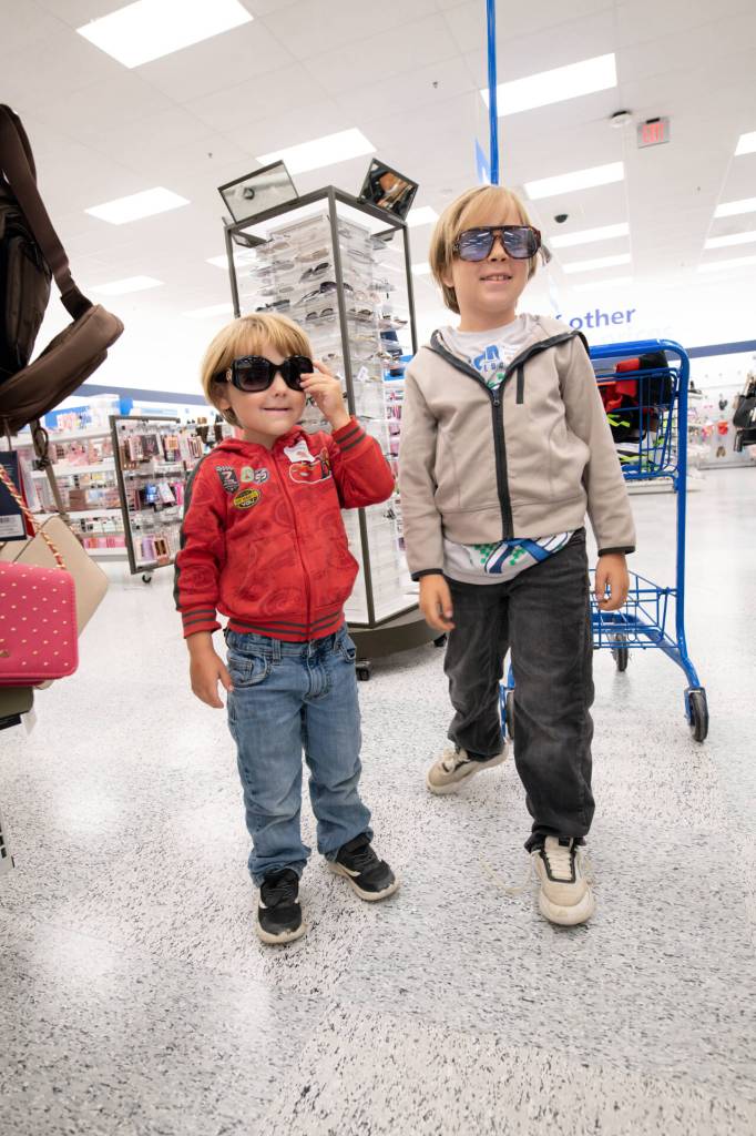 Ryder Friedman, 4, left, and his brother Asher, 7, strike a too-cool-for-school pose as they try out sunglasses displayed at Ross Dress for Less during Saturdays Shoes with Souls back-to-school shopping event.