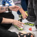 Asher Friedman tries on a new pair of school shoes with help from mom Michelle Friedman and a H.U.M.A.N. volunteer.