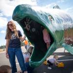 Emma Weaver, an education and outreach associate for the North Olympic Salmon Coalition, supervises as children who attended the July 30 Summer Reading Program event Stories with Fin the Salmon at the Sequim Library explore the inside of the NOSCs popular Fin the Salmon trailer.