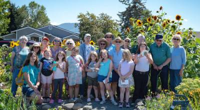 Sequim Gazette photos by Monica Berkseth/ Master Gardeners, community gardeners and kids who participate in the Sequim Boys & Girls Clubs Garden Club pose for a group photo to commemorate the youngsters field trip last week to the Community Organic Garden of Sequim.