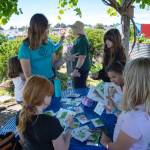 Sequim Gazette photos by Monica Berkseth/ Members of the Sequim Boys & Girls Clubs Garden Club decide which seed packets they want to take as souvenirs during their trip last week to the Community Organic Garden of Sequim. They were welcomed by Master Gardeners and community gardeners who shared gardening tips.