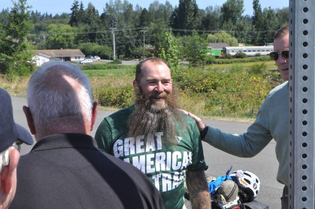Sequim Gazette photo by Matthew Nash/ Patrick Smith of Florida greets local supporters of his Warrior Bike ride on Aug. 3. Hes gone along the Great American Rail-Trail starting in Washington, D.C. and was set to finish on Aug. 4 in La Push.