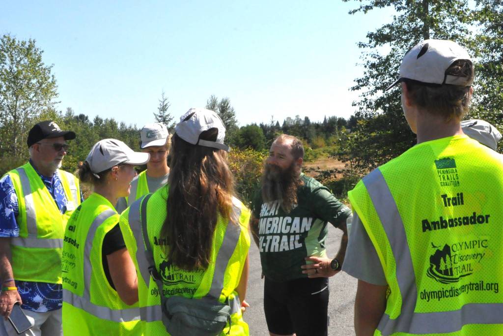 Sequim Gazette photo by Matthew Nash/ Sequim Gazette photo by Matthew Nash/ Patrick Smith of Florida greets Peninsula Trail Coalition trail ambassadors on Aug. 3.