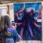 Sequim Gazette photos by Matthew Nash
A visitor takes a photo of the striking Kraken quilt by Nancy Foro at the Sunbonnet Sue Quilt Clubs annual show.