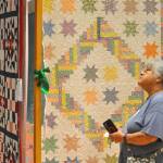 Sequim Gazette photo by Matthew Nash/ Jennie Gil of Seattle looks at various quilts during the Sunbonnet Sue Quilt Show on Aug. 7 inside Sequim Community Church. It was her first time at the show.