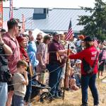 A crowd watches helicopters land on Saturday during the annual Unity of Effort.