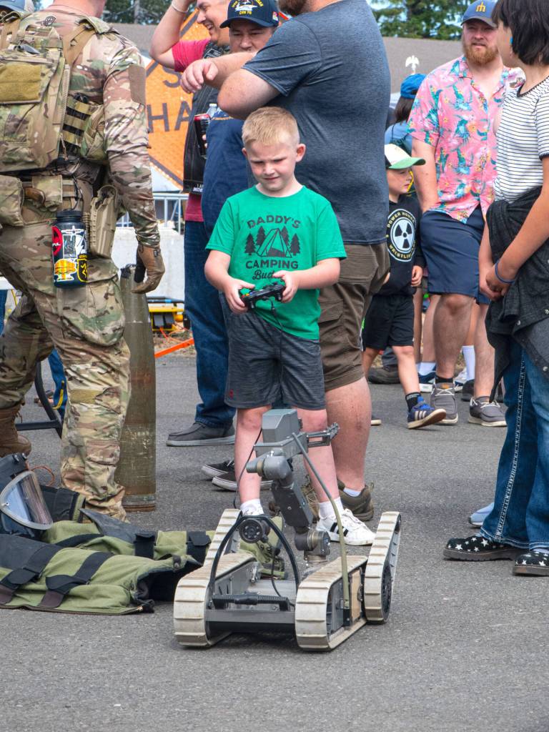 Sequim Gazette photo by Monica Berkseth/ Jackson Walchok, 6, of Seabeck tries his hand driving the robot for the Explosive Ordnance Disposal (EOD) Detachment Bangor.